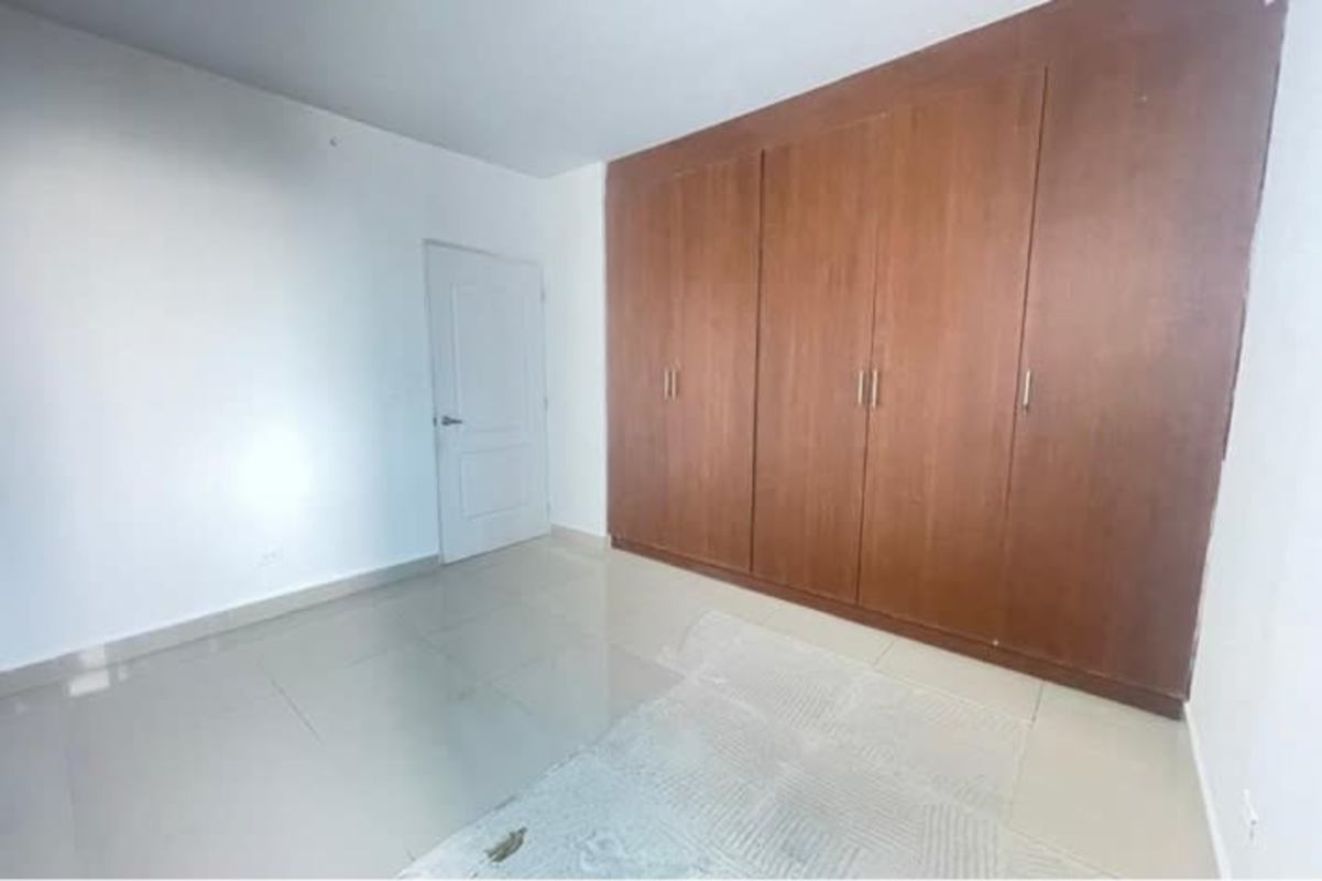 Spacious bedroom with wooden wardrobe tile floors PH El Cangrejo Bella Vista Panama