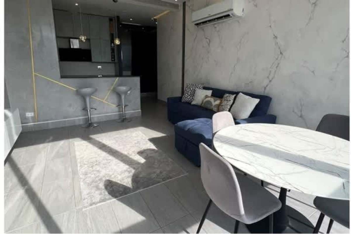 Open living dining room with city view double height penthouse PH La Loma