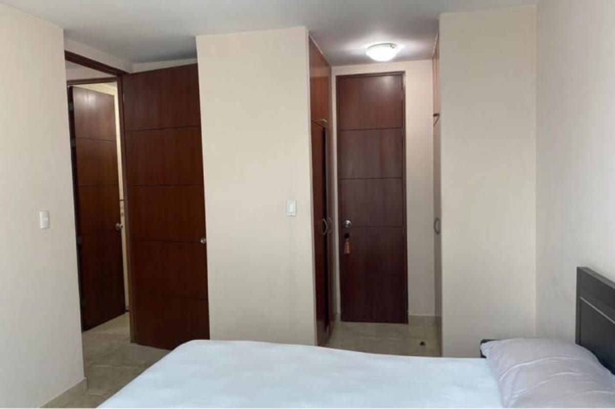 Modern bedroom with large window, built-in closet, city view Marquis Tower apartment