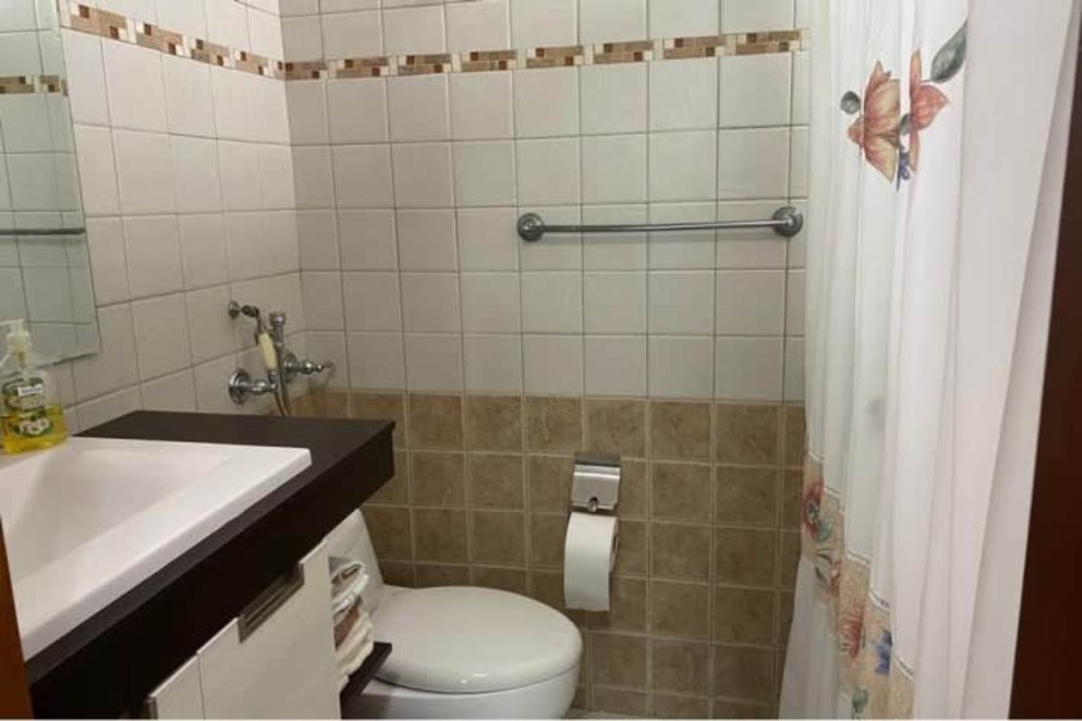 Bedroom with tile flooring, built-in closet, modern decor in Marquis Tower apartment