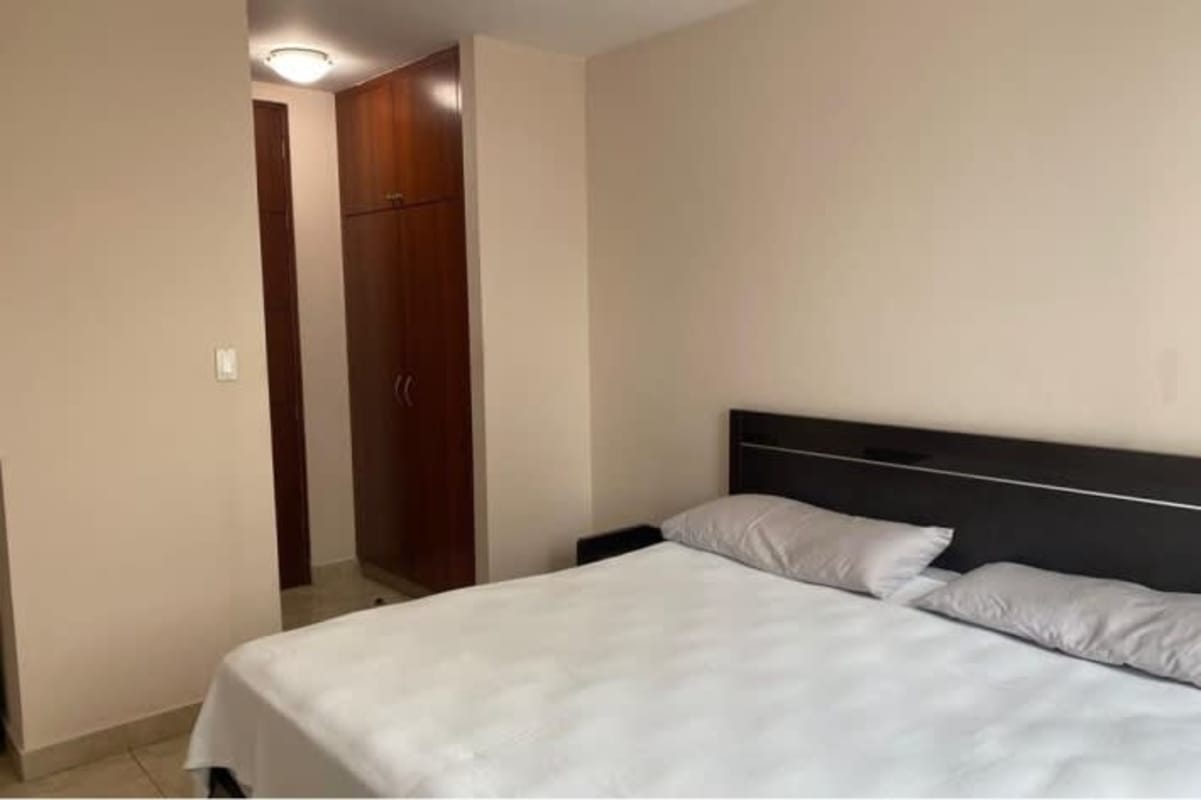 Living dining space with sliding doors to balcony, natural light Marquis Tower apartment