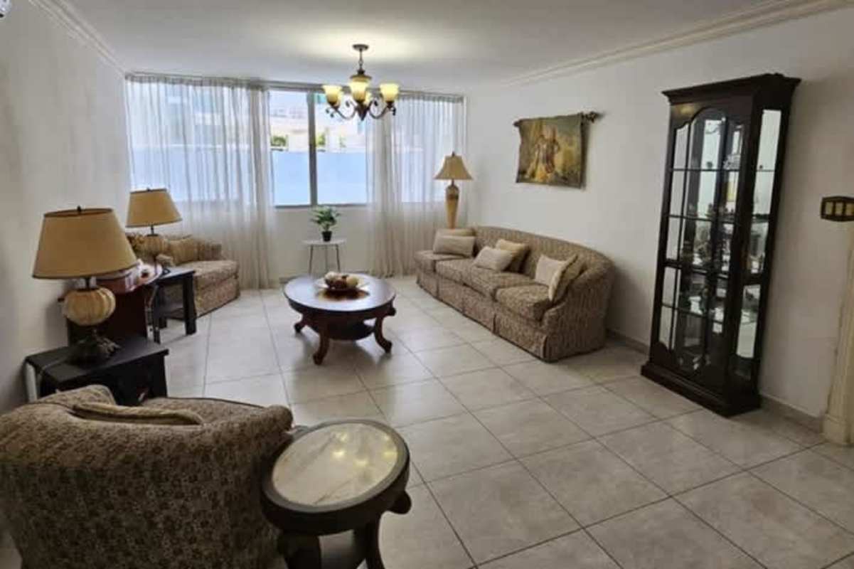 Formal dining area with chandelier, six chairs, wooden furniture in PH Mar Plaza apartment Panama City