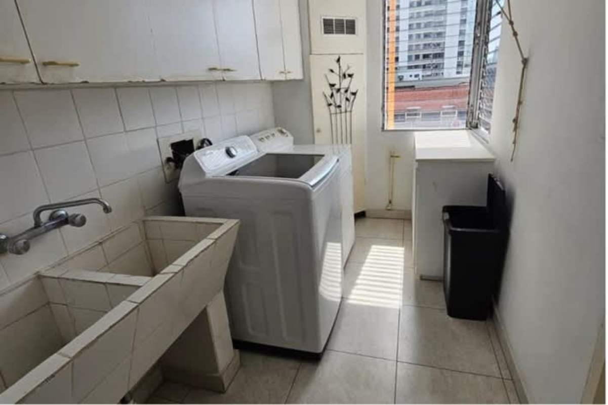 Laundry with washer, double utility sink, storage cabinets, large window in PH Mar Plaza Marbella Panama