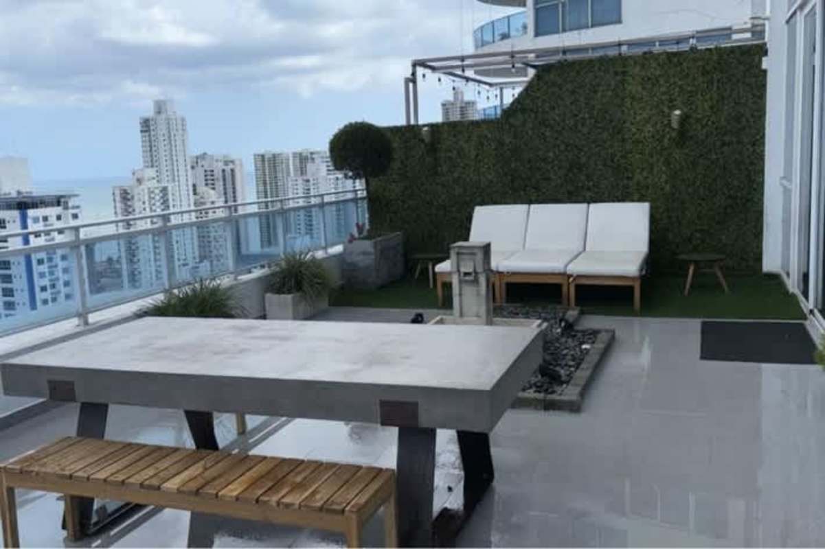 Open concept furnished living and dining area, loft style, panoramic windows of PH Premium Tower Panama City