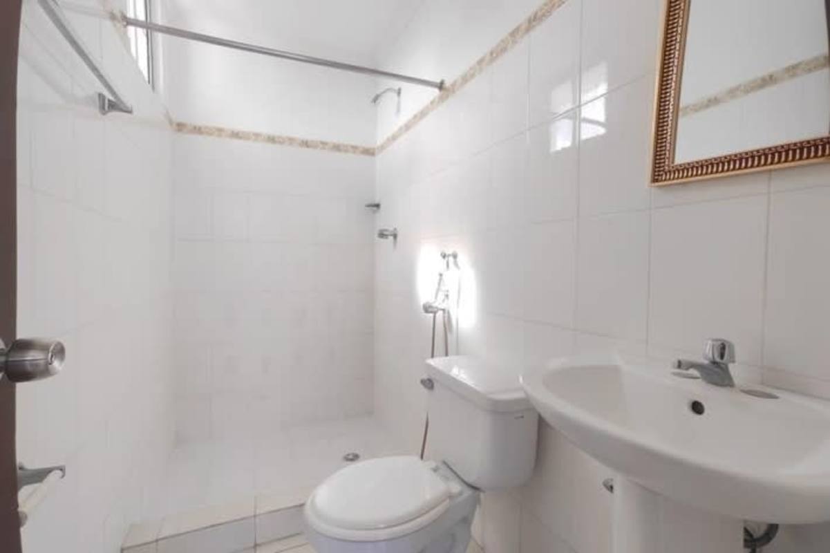 Empty bedroom with built-in closet ceiling fan tile floors at PH Mystic Hills El Crisol Panama