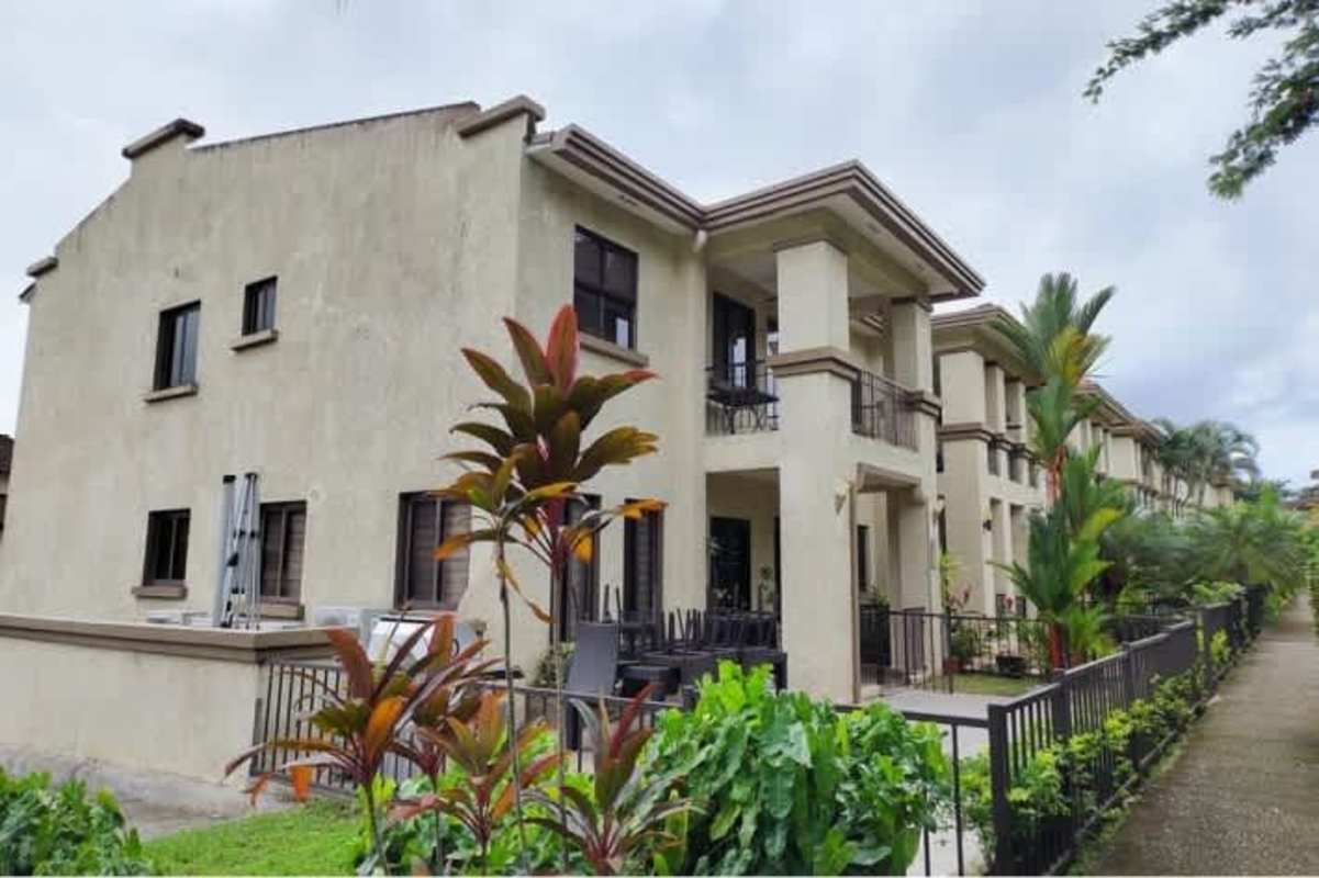 Two-story townhouse with balconies, landscaped gardens, Embassy Club Clayton Panama