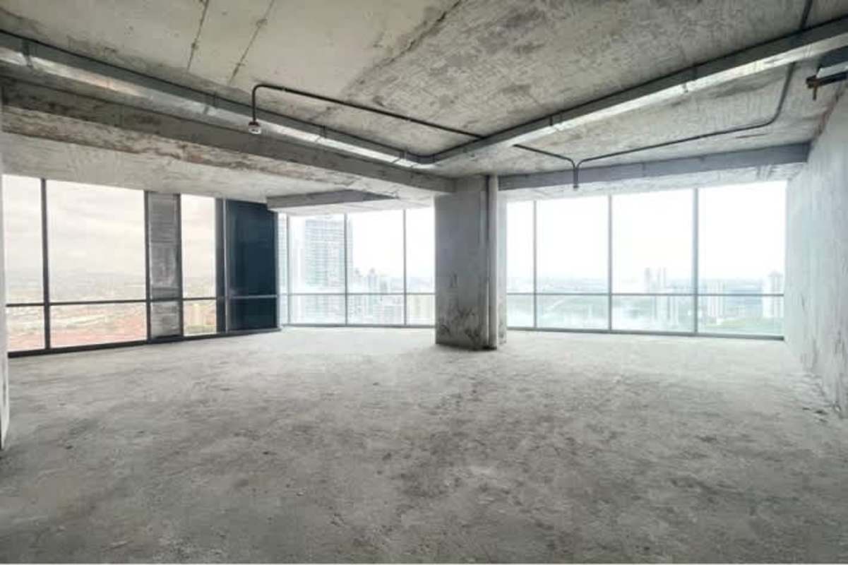 Open plan industrial shell office with exposed concrete and large windows in Costa del Este Panama
