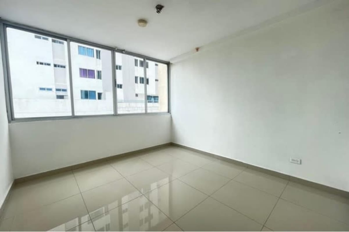 Modern bathroom with pedestal sink and walk-in shower tiled in beige at PH Carrasquilla Park Panama City