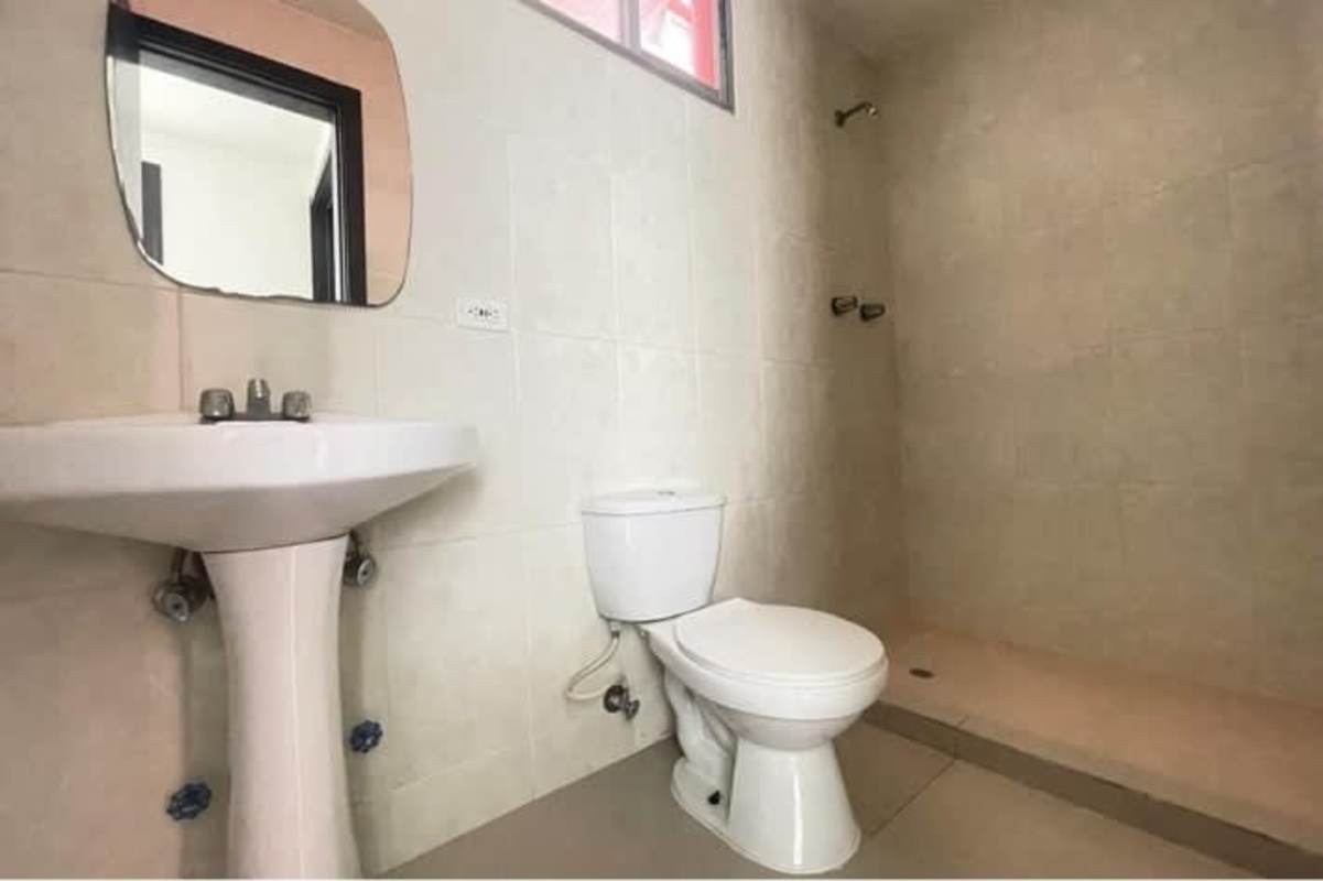 Second bedroom with bright window and tile sidewalks in PH Carrasquilla Park Panama City