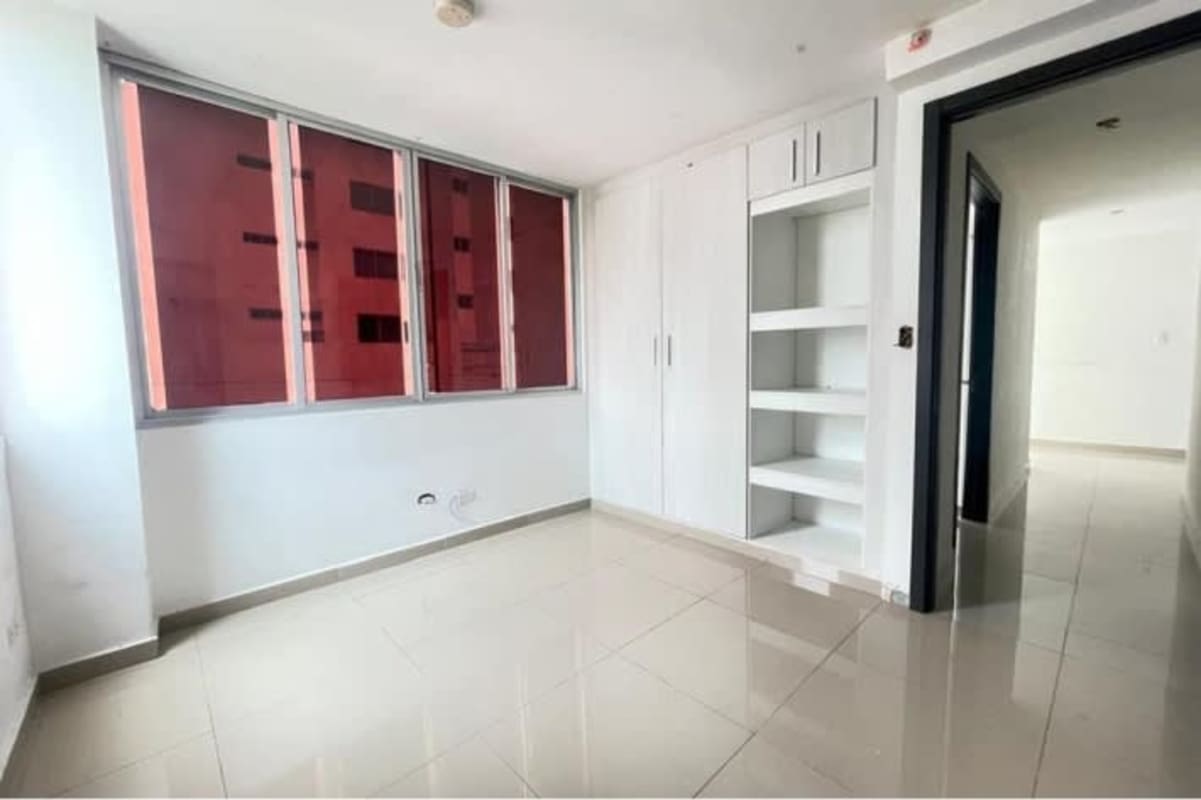 Modern bedroom with large window and built-in wardrobe in PH Carrasquilla Park San Francisco Panama