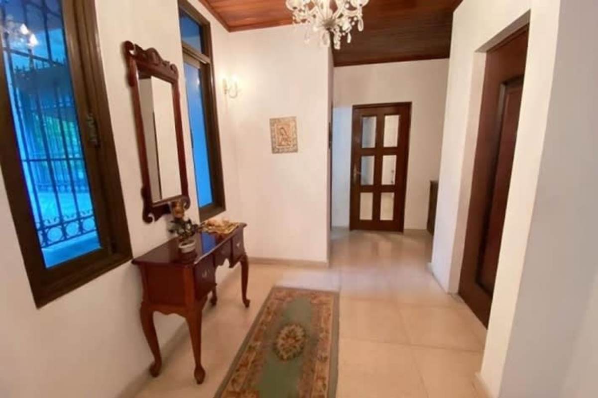 Grand entry hallway with chandelier, wood ceiling, vintage decor in Panama City luxury house