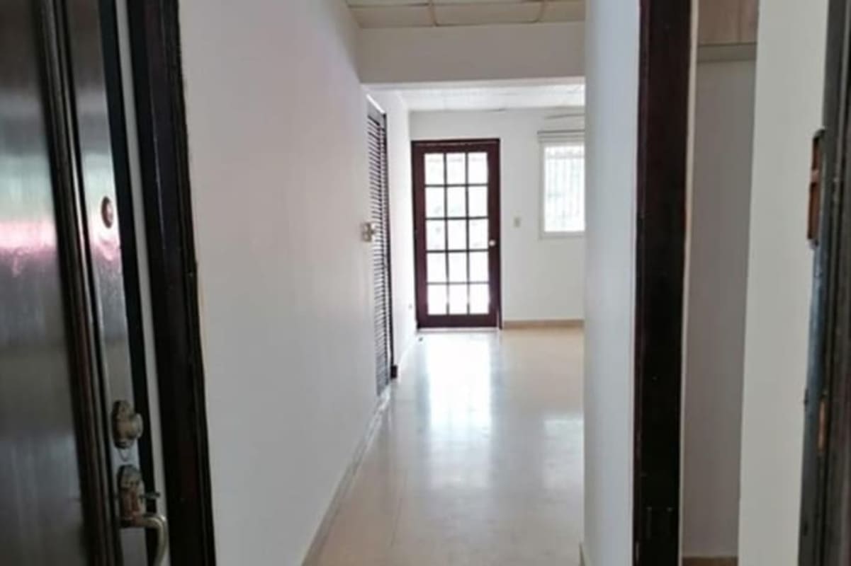 Interior hallway with glass panel door leading to balcony PH Obarrio Plaza Panama rental