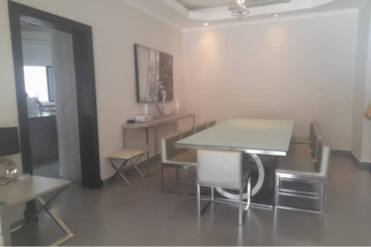 Modern backyard design with swimming pool, jacuzzi, deck, and tropical landscaping in luxury residence Costa del Este Panama