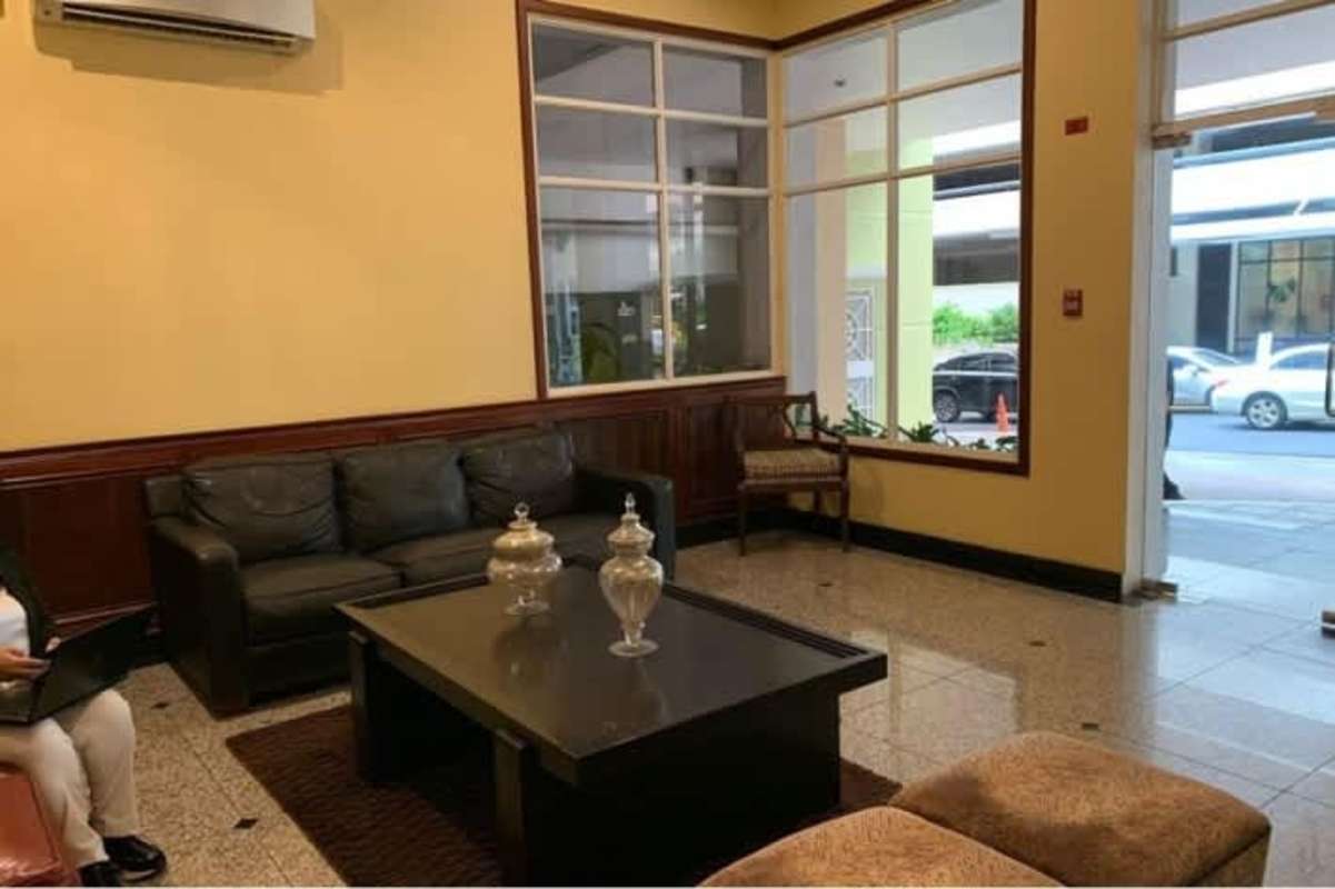 Contemporary dining area with large windows and modern chandelier at Victoria Tower Panama