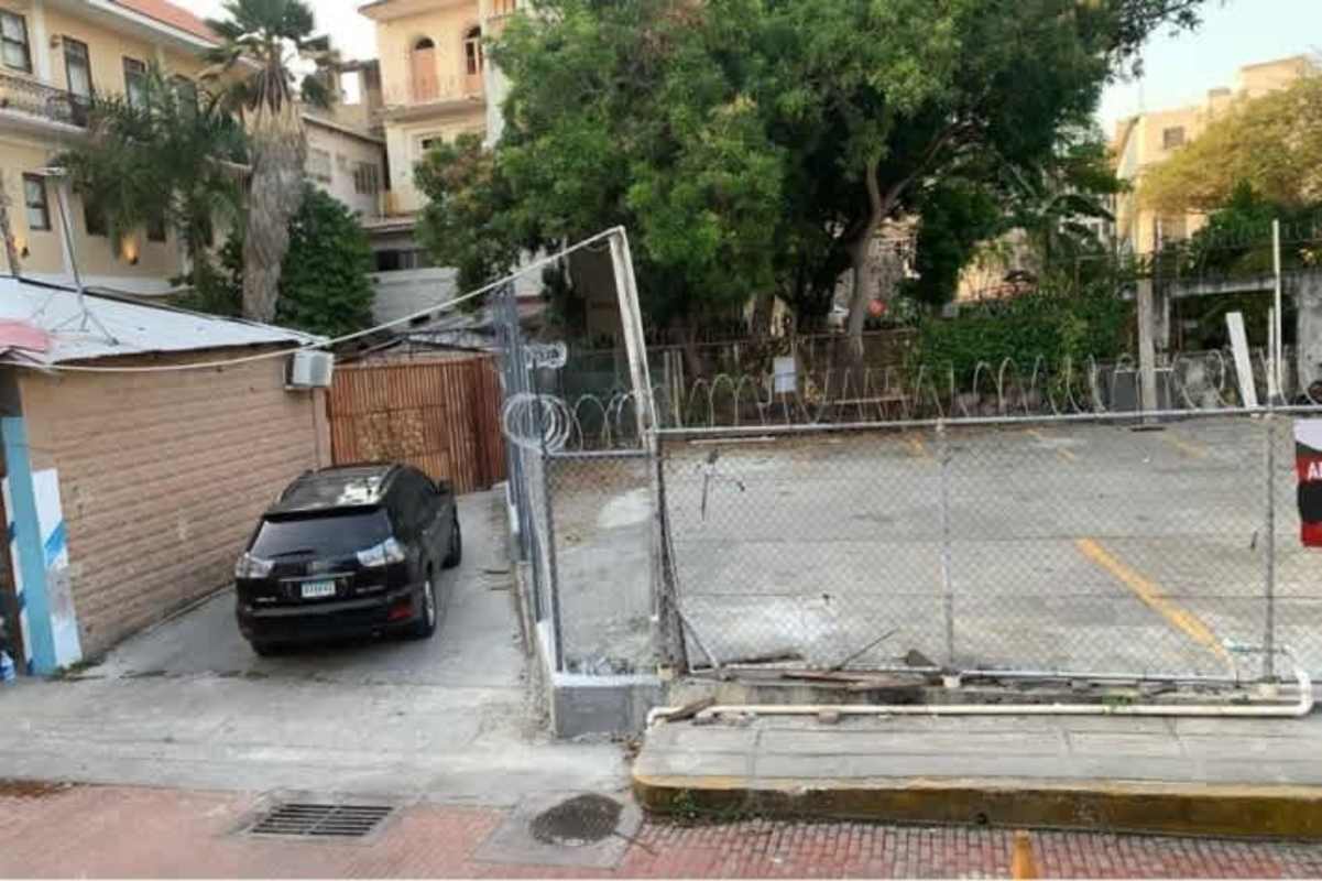Corner commercial lot with secure fencing and city backdrop at Casco Viejo Panama
