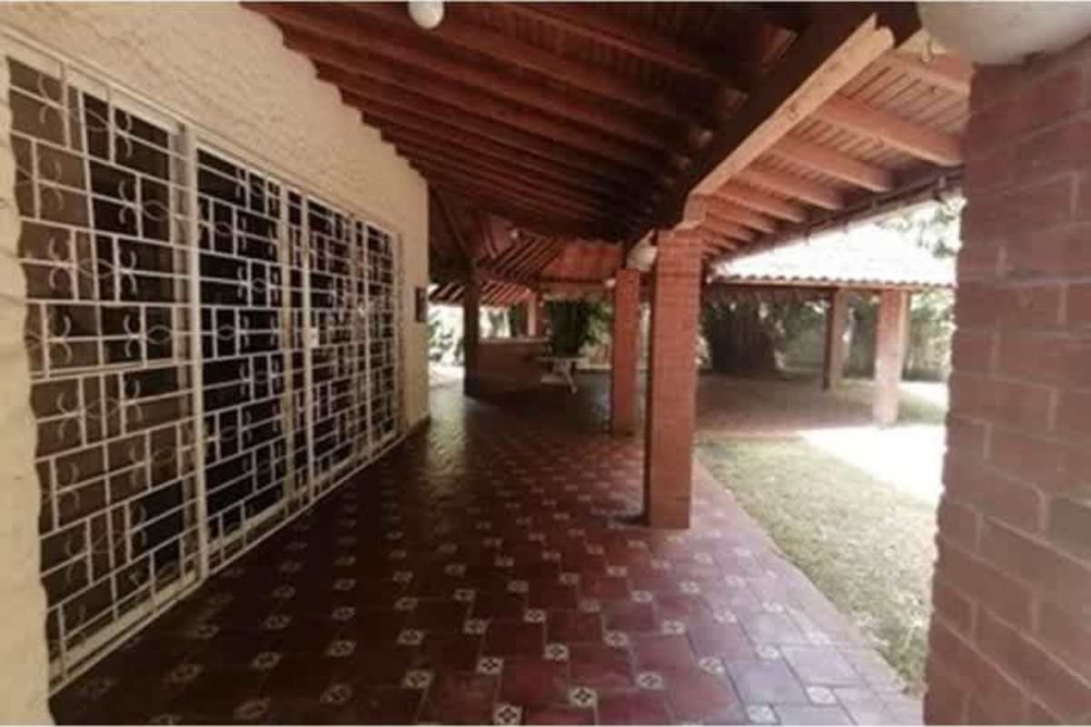 Covered rustic outdoor gazebo with terracotta tiles and bar area ideal for entertaining in Las Cumbres Pedregal Panama City