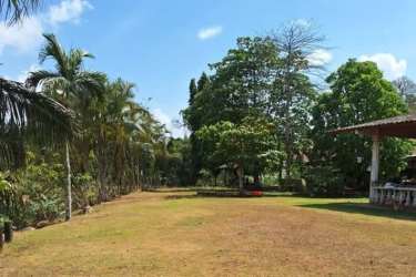 Rustic house structure with clay tile roof, arched windows on farm land Nuevo Emperador Arraiján