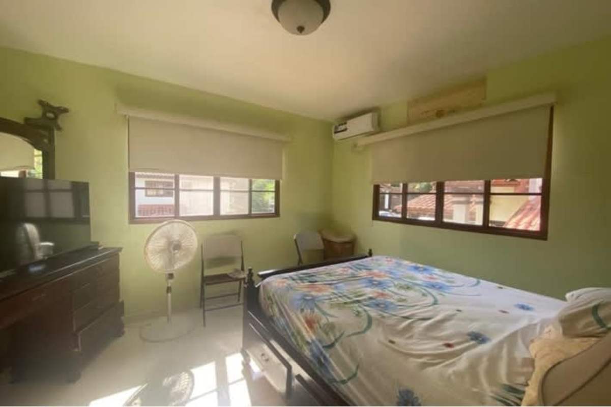 Bright living room with wicker sofas, large windows Las Cumbres Panama