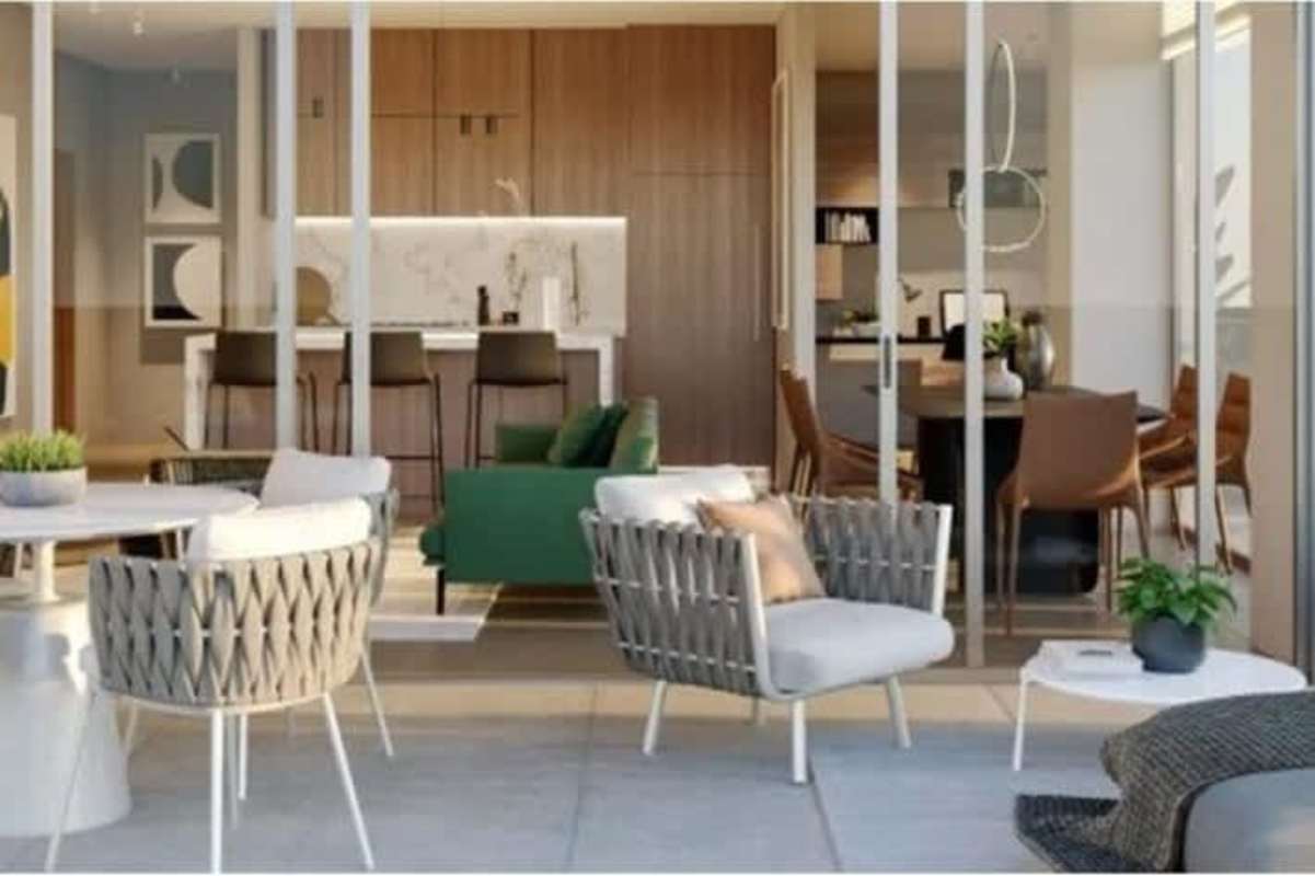 Patio terrace with woven chairs connected to kitchen dining area in PH Nogal Panama