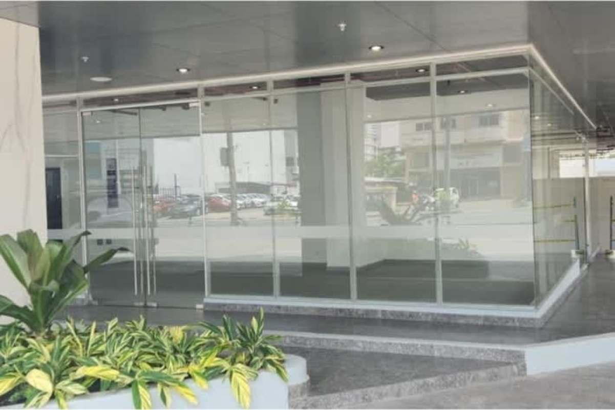 Open shell commercial space with tiled floor, white walls, exposed ceiling ready for build out Panama