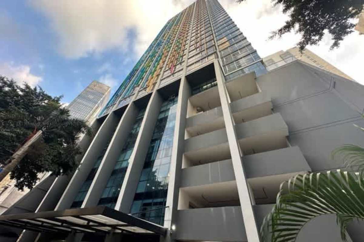 Urban skyline modern high-rise with glass facade balconies colorful accents at PH Colores de Bella Vista Panama