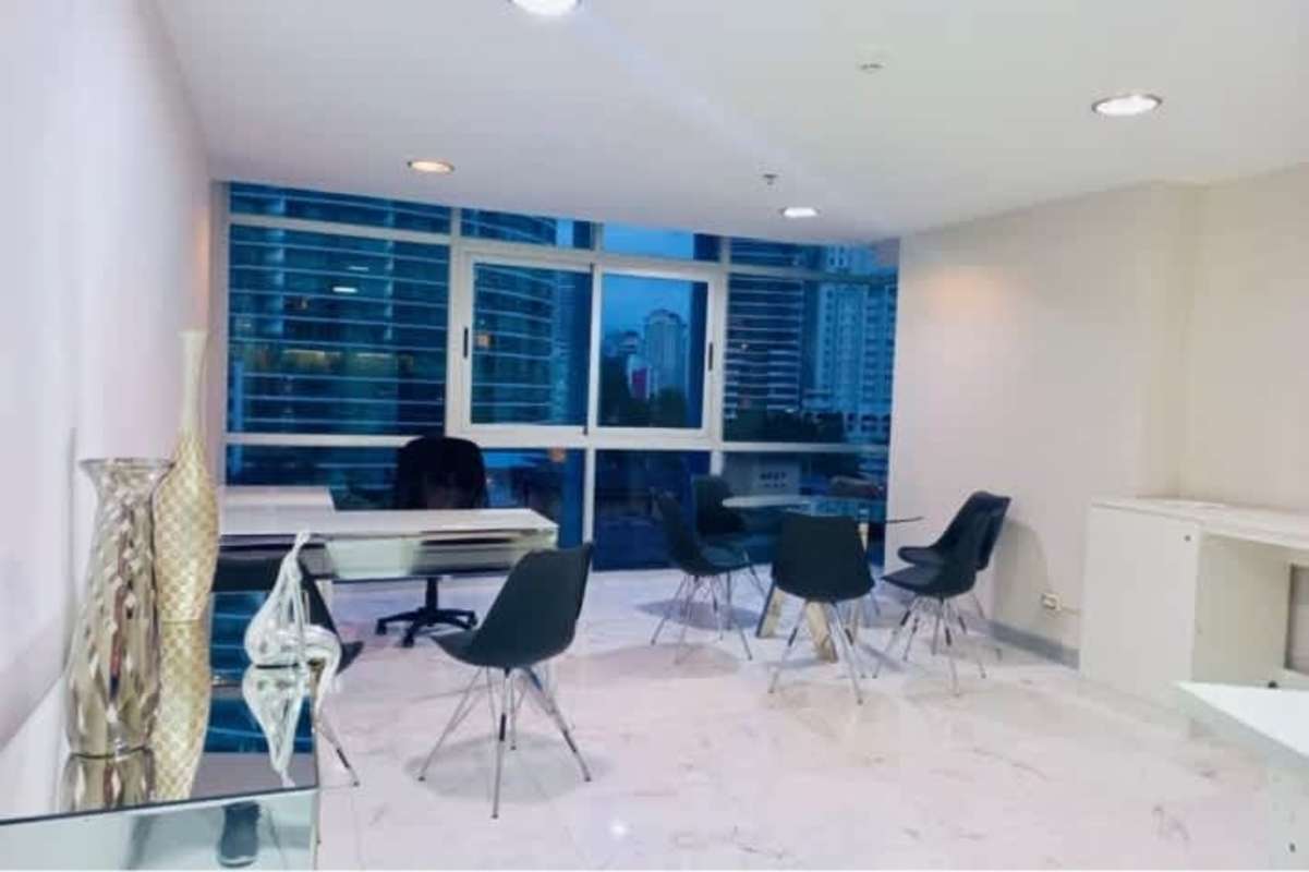 Minimalist office nook with marble floors, white desk and city view window at PH Colores de Bella Vista Panama