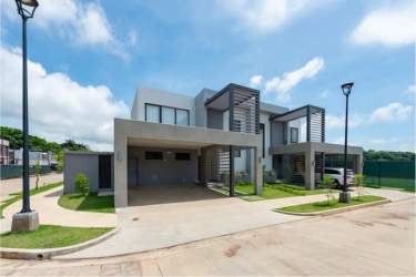Modern kitchen with granite counters and dining area in Panama Pacifico house