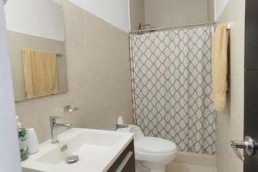 Contemporary kitchen with granite counters stove refrigerator microwave in Paraíso Village Panama beach condo