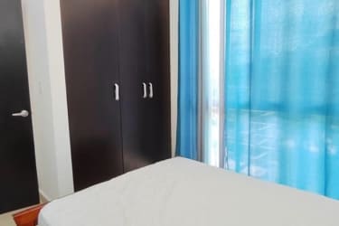 Large pool area surrounded by palm trees tropical gardens sun loungers at PH Paraíso Village Coronado Panama condo for sale