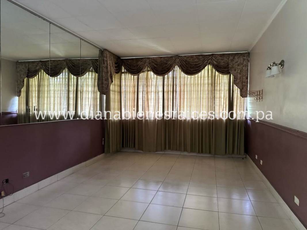 Covered terrace overlooking garden and pool area in residential house El Carmen