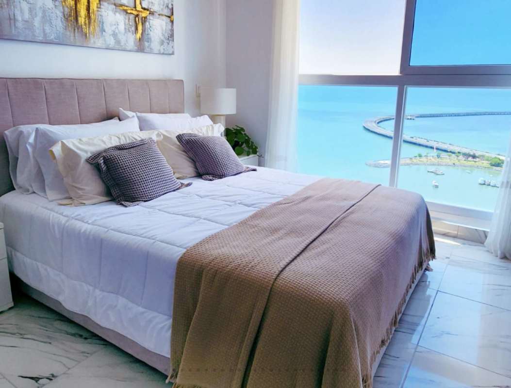 Bright bedroom with large window ocean view marble flooring PH The Sands Panama