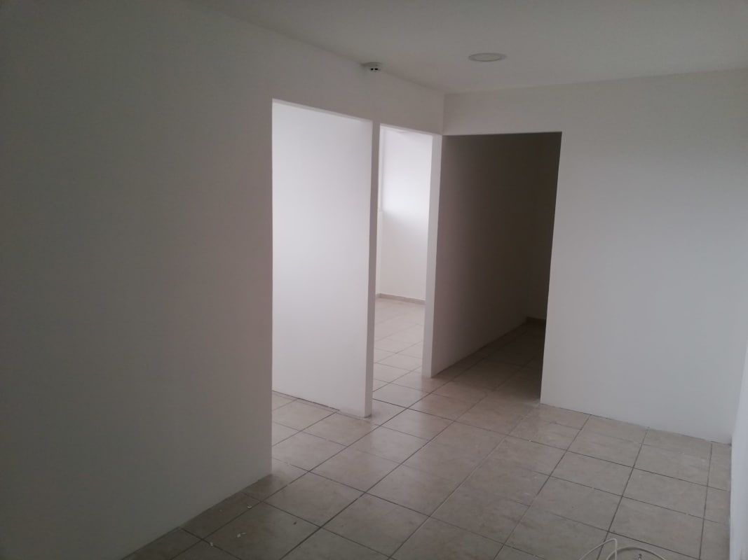 Minimal hallway interior with tiled floors and white walls inside PH Bay View commercial offices Panama