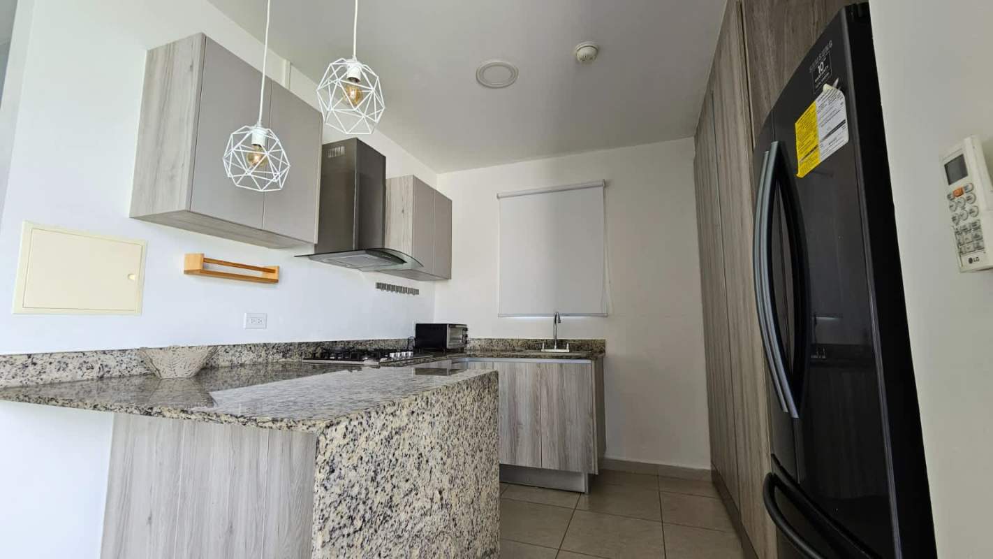 Covered terrace with private garden and outdoor dining area in Costa Sur Panama