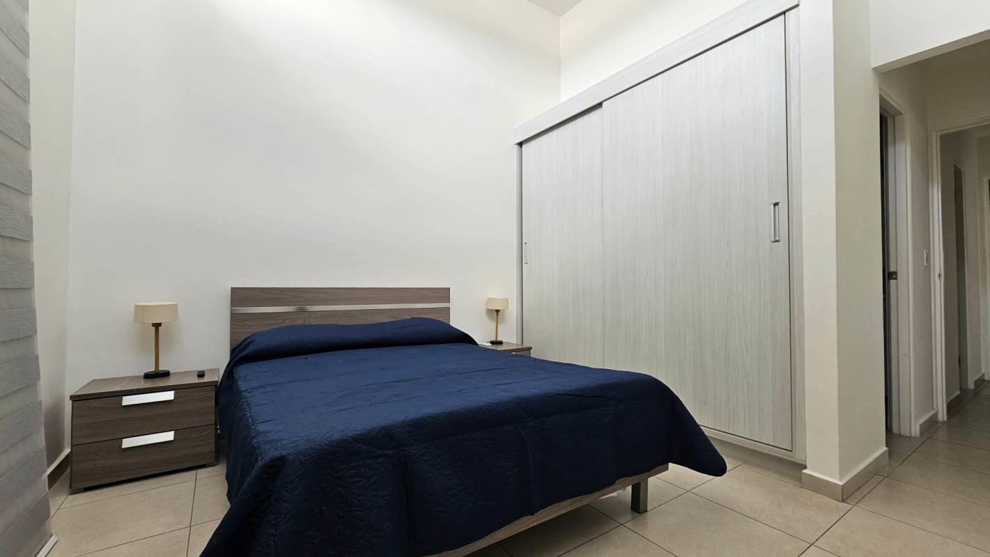 Open plan living and dining room with ceramic floors in Costa Sur house