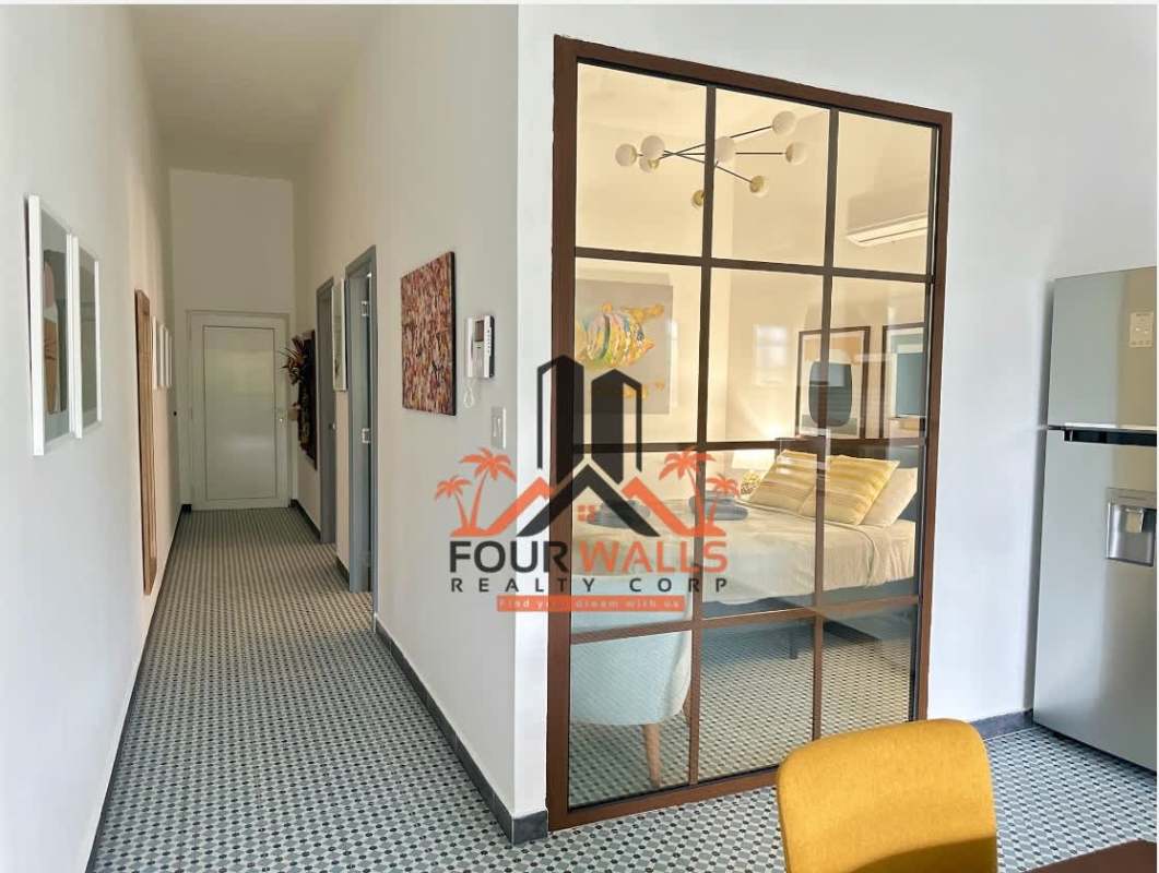 Open plan dining and kitchen with colonial tiles and large window in PH La Quinta Casco Viejo