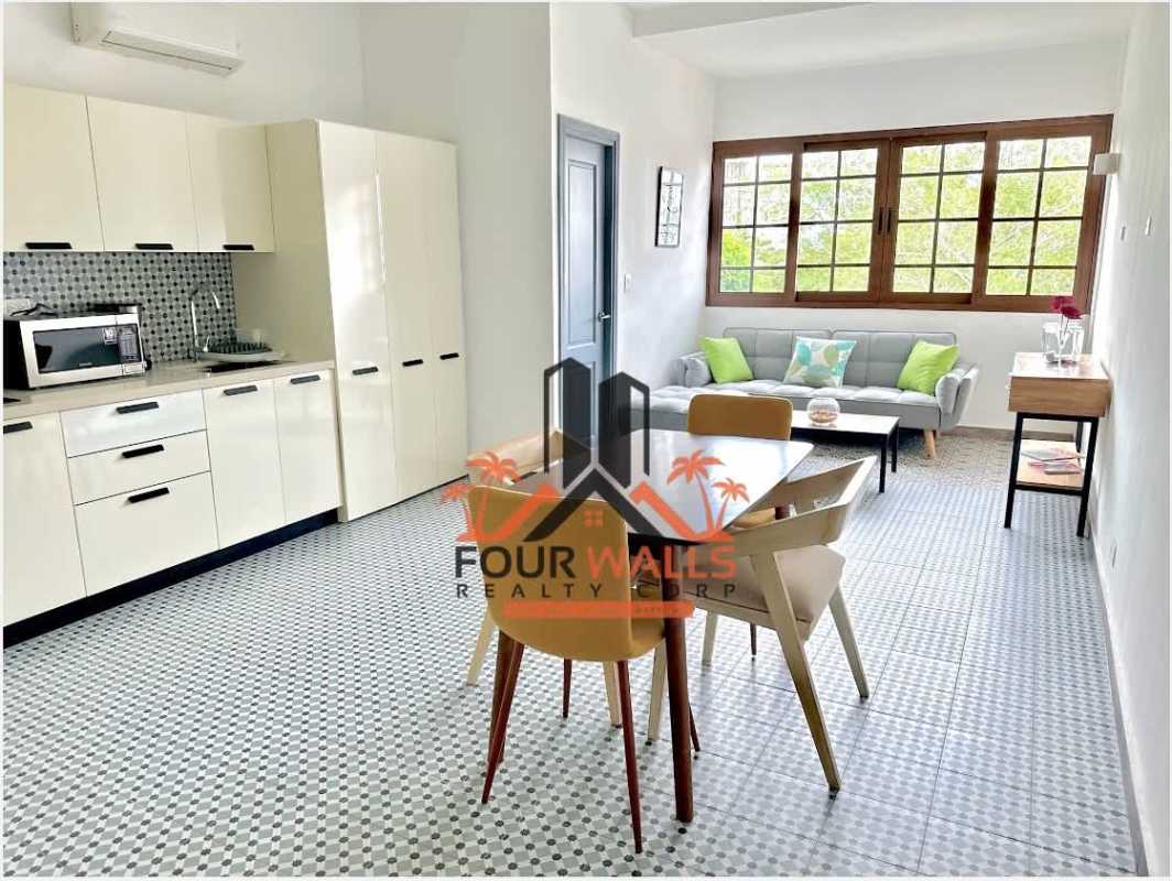 Modern open kitchen and living space with colonial tiles PH La Quinta Casco Viejo Panama