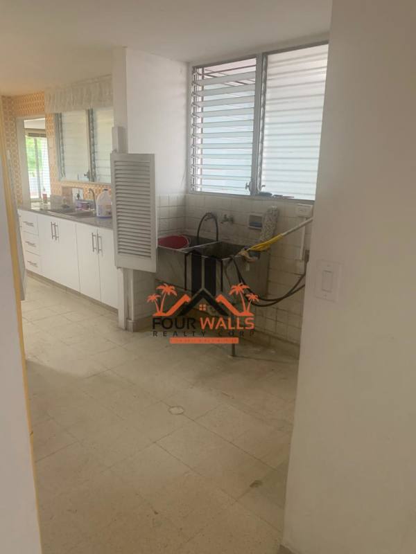 Kitchen with granite countertop, patterned tile and large windows at PH Fiesta Obarrio