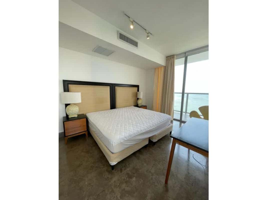 Minimalist bedroom with large window and ocean view at PH Yoo Panama