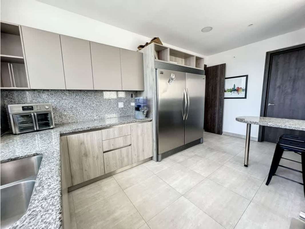 Modern kitchen with stainless appliances, granite countertops, large window in PH Asia