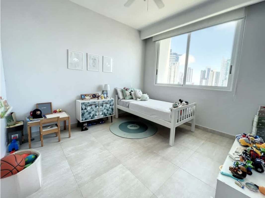 Bright kids bedroom with colorful bedding, large window, city view PH Asia Panama