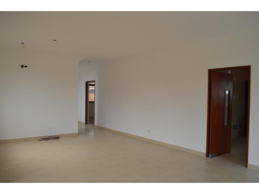 Bright hallway with neutral floors and wooden accents in new house PH El Doral Costa Sur Panama City