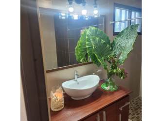 Single story white house with tile roof lush garden PH Piedras Gordas San Carlos Panama