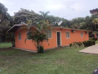 Interior hallway with tiled flooring and yellow painted walls in rental property Santa Clara Panama