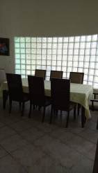 Bright dining area with glass block window and six chairs at Panama vacation rental