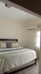 Spacious bedroom with king bed, AC, modern decor in Coronado Panama rental