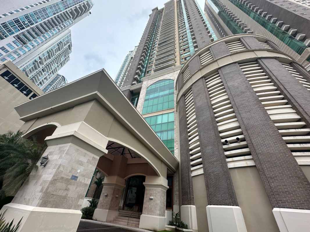 Pacific Point condominium tower's elegant entrance with archways and palm landscaping Panama City