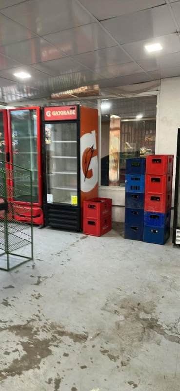 Industrial style interior with storage racks, coolers, and concrete floor in Pedregal commercial unit