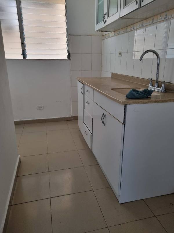 Simple kitchen with granite countertop and window in affordable apartment Panama