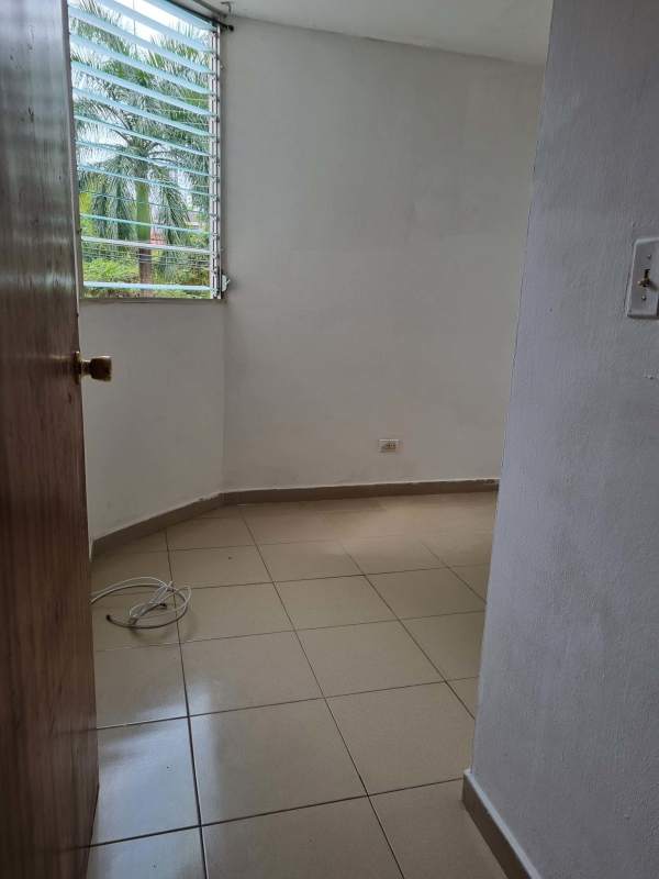 Bedroom featuring window with garden view ceramic floor in Río Abajo Panama apartment for sale