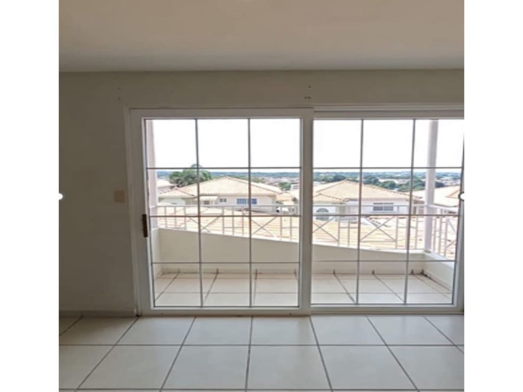 Bright living room with tile floor and balcony doors in house Brisas del Golf Panama City